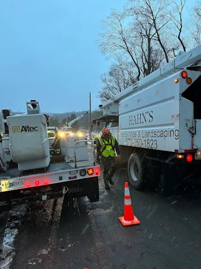 Fleet of company trucks staged on a snowy road during an emergency response